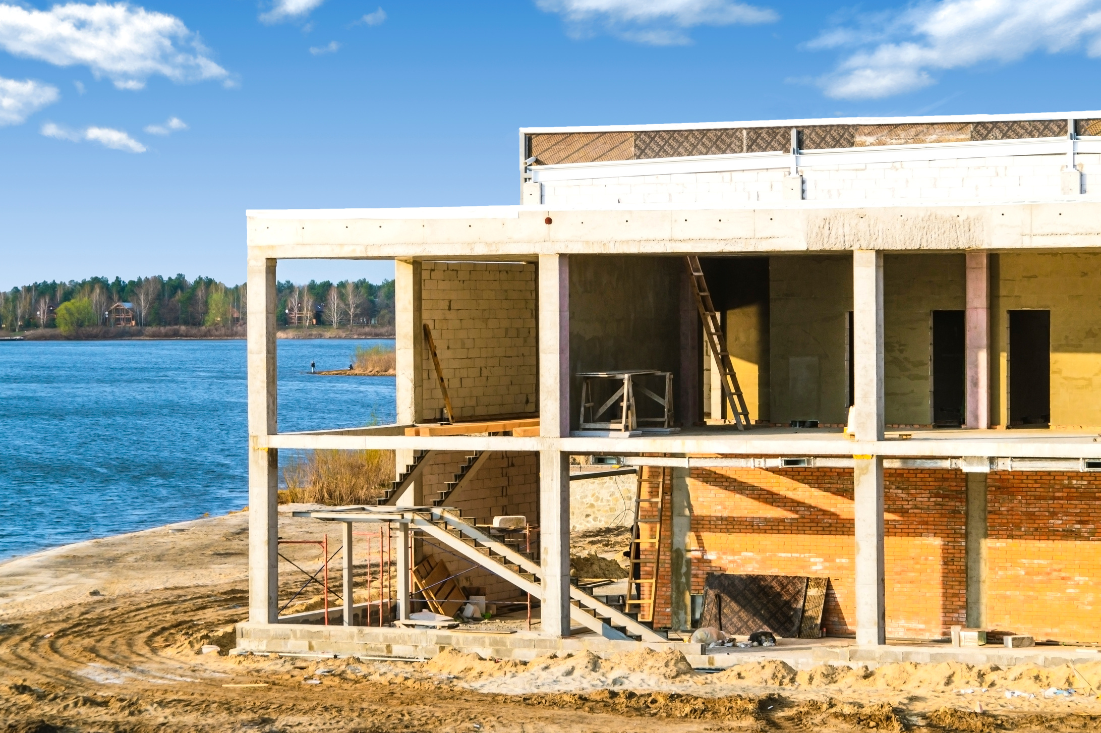 House under construction on the river bank.